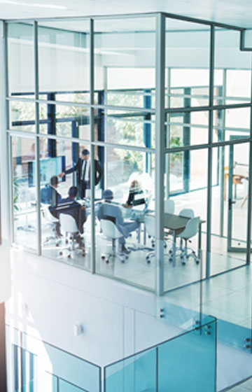 Modern Glass Office - Image of Professional Employees Working Inside the Offcie.